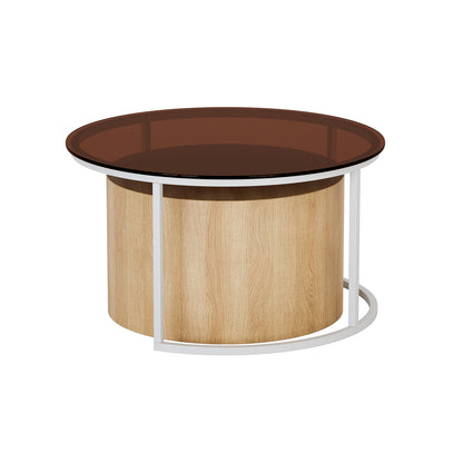 Ellisha Round Nesting Coffee Table in Natural featuring a circular tinted-brown glass top, light oak-grain cylindrical base, and white powder-coated metal frame supporting the glass surface, exemplifying modern elegance and practicality.