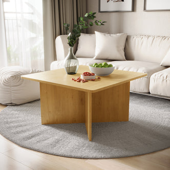 Emelia 80cm Square Coffee Table Oak displayed in a stylish living room, showcasing its modern square shape on a floor beside a couch, enhancing the space with its elegant design.
