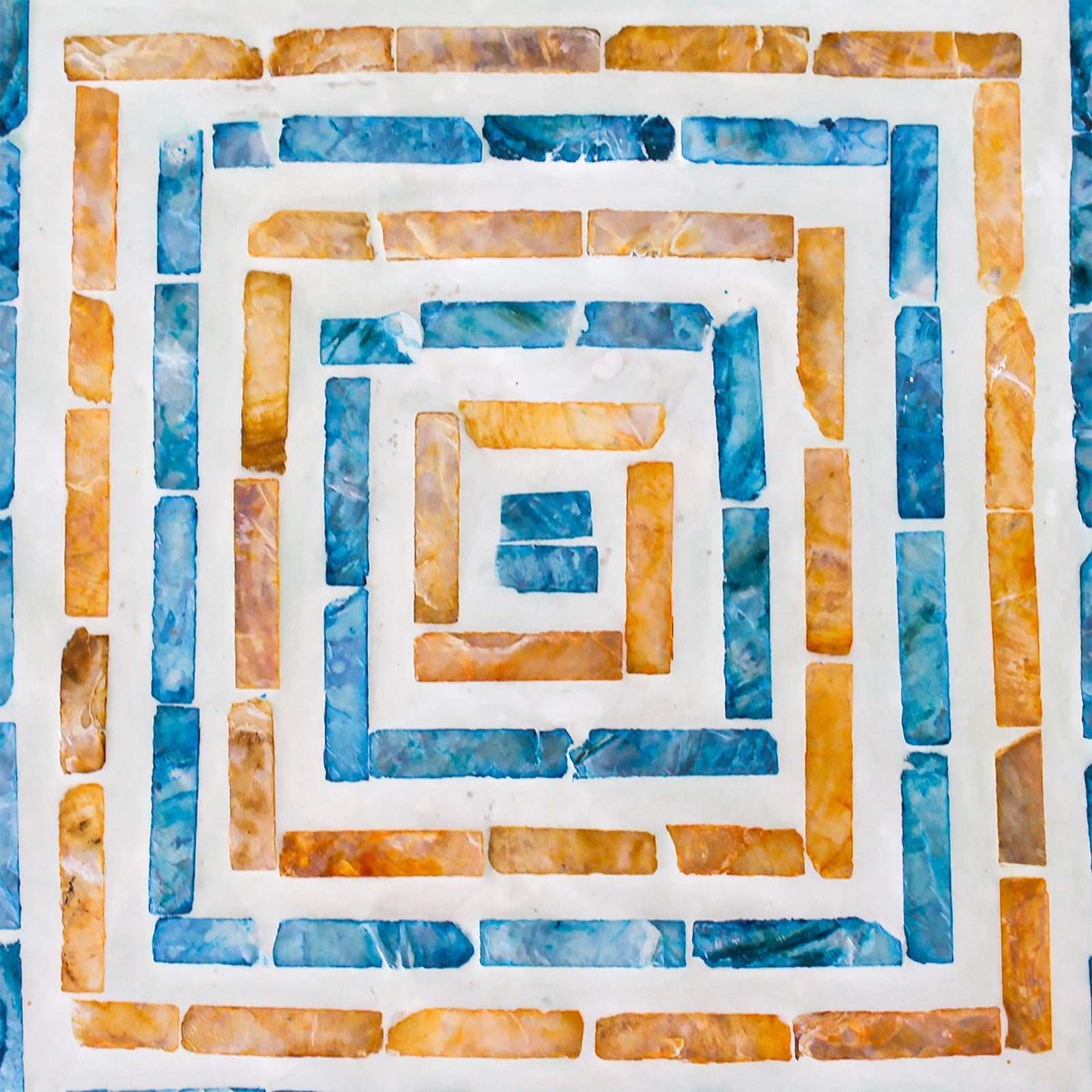 Enki 35cm Mother of Pearl Inlay Side Table in Orange & Blue features a geometric concentric square mosaic with amber and teal tiles, set in light grout, showcasing intricate craftsmanship.