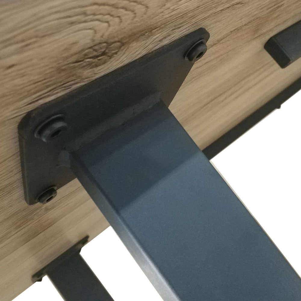 Underside of the Ernest 200cm 6 Seater Industrial Dining Table in Natural, showing a square-tube metal leg with black powder coating, securely bolted with screws to the wooden tabletop.