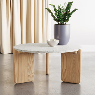 Everlee Hardwood American Oak Coffee Table in Natural, featuring a light-speckled terrazzo-style top with chunky rounded wooden legs, adorned with a grey-lavender pot holding a leafy ZZ plant.
