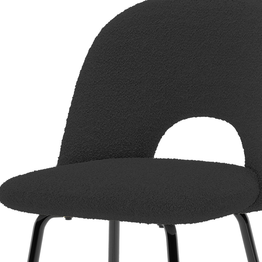 Evie High Back Boucle Bar Stool Set of 2 in Black, featuring a close-up of the plush boucle-style upholstered seat and back with a cut-out, atop sleek, slender metal legs.