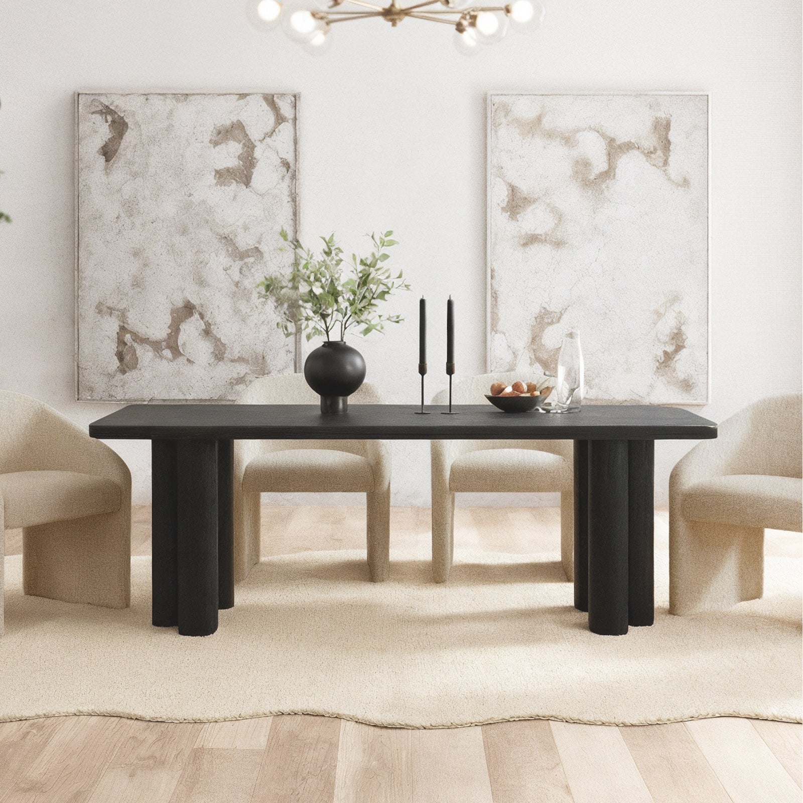 Faunus 200cm 8 Seater Dining Table in Black, featuring a sleek rectangular design with thick cylindrical legs, surrounded by cream chairs and topped with decorative items, set on an off-white rug.