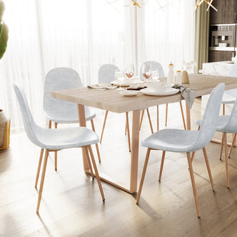 Florida PU Leather Dining Chairs Set of 4 in Slate, featuring sleek light-upholstered seats with slim wooden legs, elegantly surround a modern light-wood dining table set in an airy, minimalist dining area.