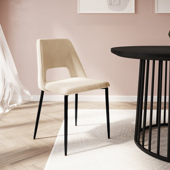 Geena High Back Velvet Dining Chair Set of 2 in Oatmeal, featuring upholstered beige seat and backrest, slender black metal legs, shown in a modern dining nook with minimalist decor and herringbone flooring.