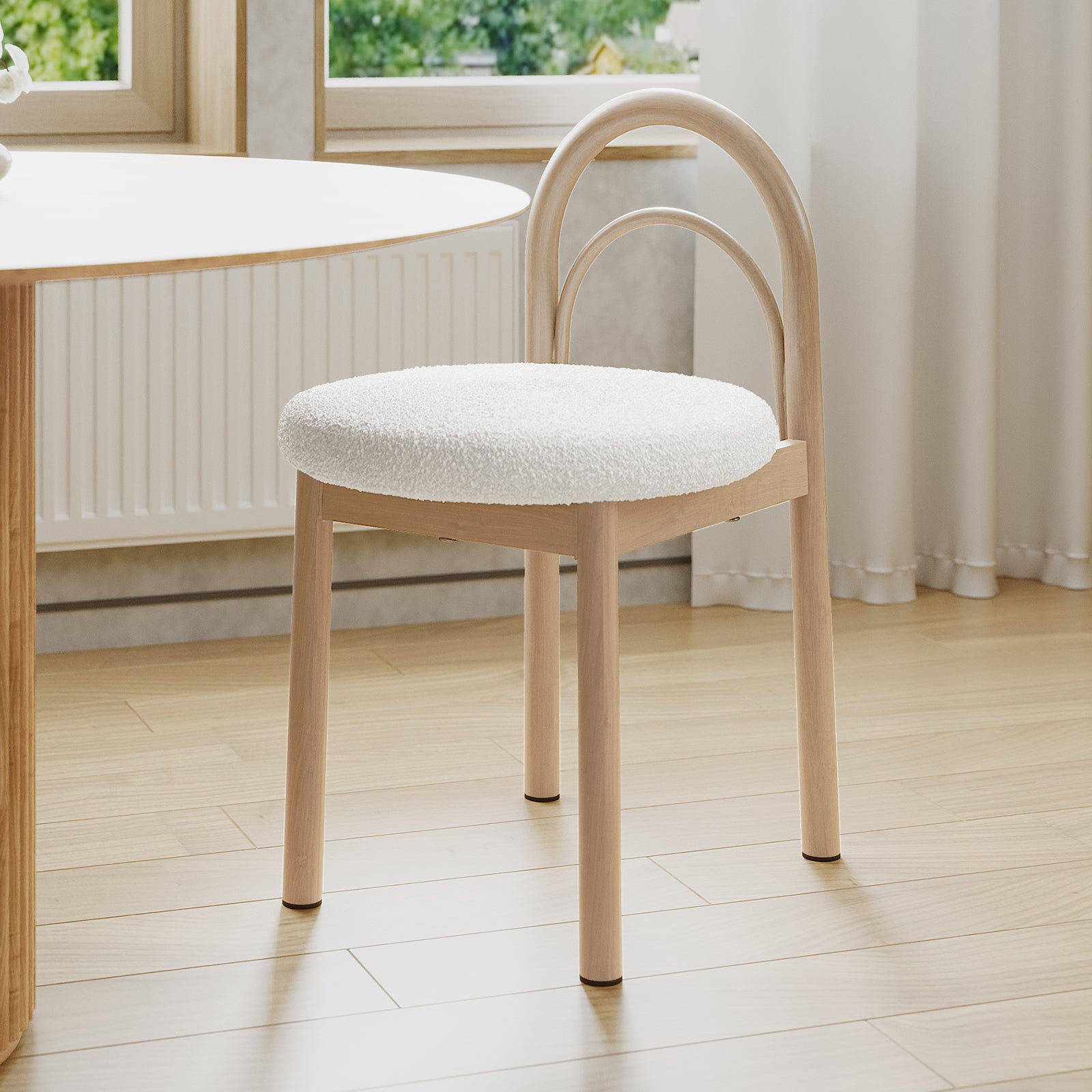 Gilles Boucle Arched Dining Chair Cream White Set of 2, featuring arched backrests and plush seats, shown near a table, highlighting luxurious boucle fabric and sturdy metal frames.