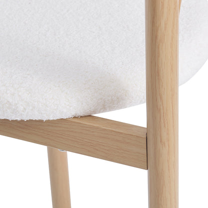 Close-up of Gilles Boucle Arched Dining Chair Cream White Set of 2, showcasing the textured wood grain on the powder-coated metal frame and boucle fabric, highlighting the elegant double-arched backrest design.