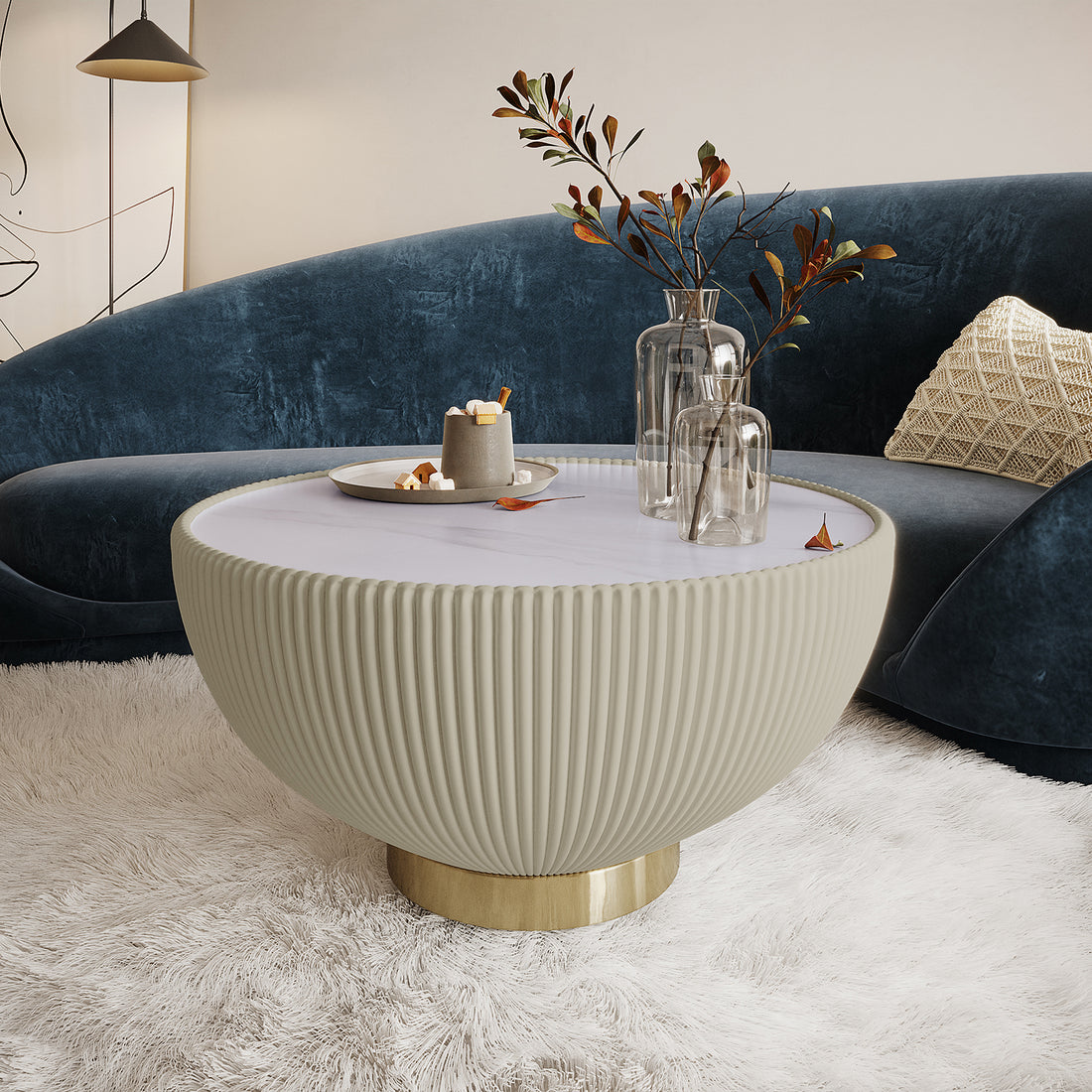 Glalie 70cm Sintered Stone Coffee Table Cream White with fluted exterior, smooth top, and brass base, styled with glass vases and decorative tray, set on a plush shag rug.