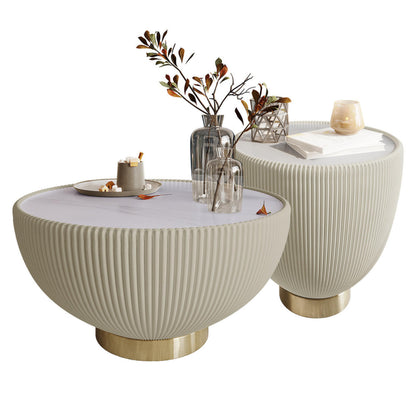 Glalie Sintered Stone Coffee Table Set in Cream White features modern half-sphere tables with ribbed exteriors, polished brass bases, topped with autumn-themed vases, books, and a candle holder.