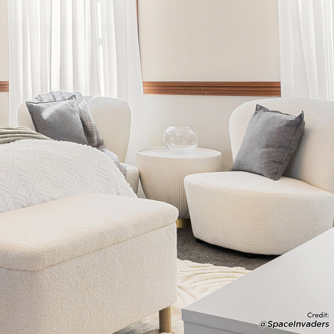 Glalie 47cm Sintered Stone Coffee Table in Cream White, featured in a cozy seating nook with neutral tones, subtly enhances the minimalist setting with its sleek, rounded shape and elegant design.