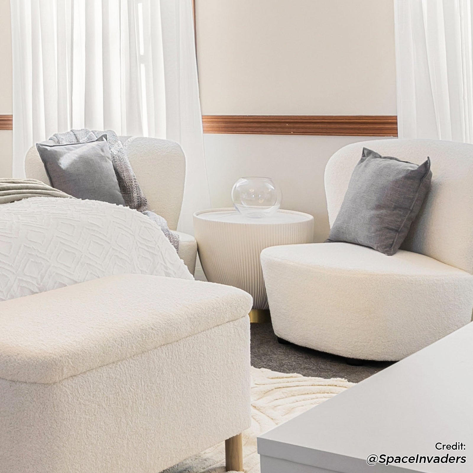 Glalie 47cm Sintered Stone Coffee Table in Cream White, featured in a cozy seating nook with neutral tones, subtly enhances the minimalist setting with its sleek, rounded shape and elegant design.