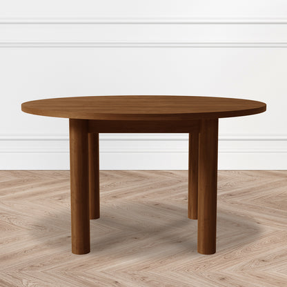 Hudson 80cm Round Hardwood Coffee Table in Walnut features a smooth, walnut-toned top with three sturdy cylindrical legs, set against a chevron-patterned wood floor and white paneled wall.