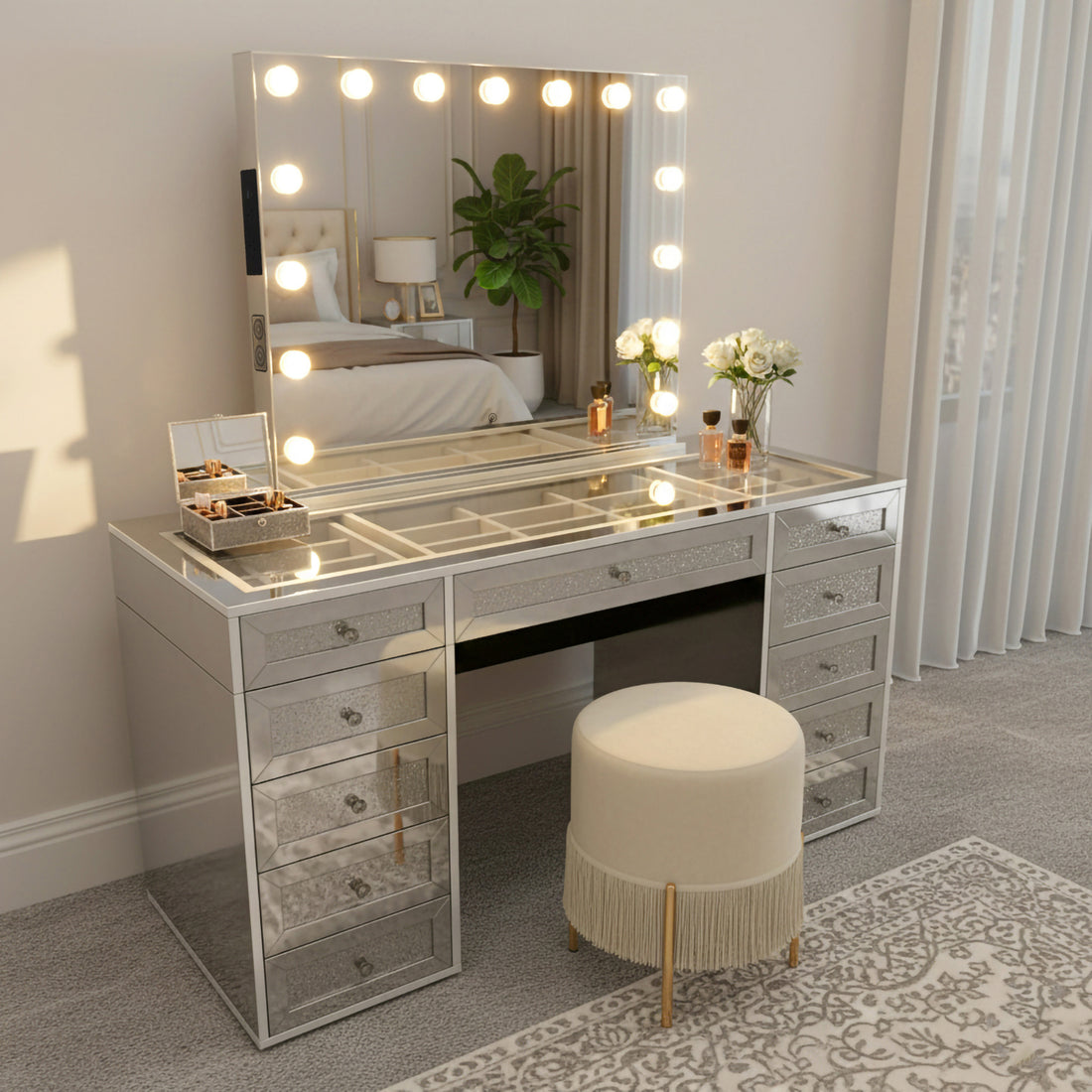Ivy Diamond Crystal Mirror Finish Hollywood LED Vanity Table with glowing bulb-framed mirror, mirrored drawers, and tempered glass top, featuring beauty items, vanity stool, and elegant bedroom setting.