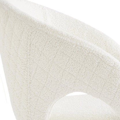 Close-up of the Jazlyn Bouclé Dining Chairs with Gold Legs Set of 2 in Cream, highlighting the textured bouclé fabric on the curved back/arm of the tub-style accent chair.