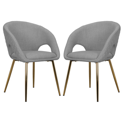 Jazlyn Fabric Dining Chairs with Gold Legs Set of 2 in Grey, featuring curved upholstered shells with cut-outs at arm-backrest junction, supported by slender gold-tone metal legs, offering modern elegance.