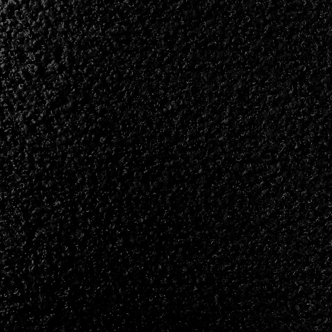 Julie Bouclé Upholstered Accent Chair - Black, showcasing plush bouclé fabric, curved design, and thick padding on a sturdy frame, highlighting its modern luxury and comfort-focused features.