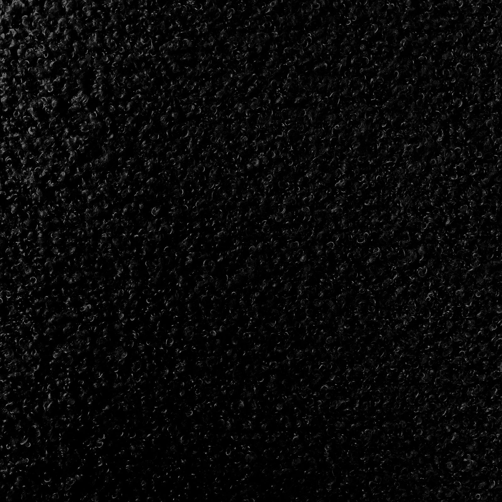 Julie Bouclé Upholstered Accent Chair - Black, showcasing plush bouclé fabric, curved design, and thick padding on a sturdy frame, highlighting its modern luxury and comfort-focused features.