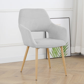 Light grey Keith Fabric Dining Chair Set of 2, featuring a modern upholstered design with a curved backrest, integrated armrests, and four tapered natural-wood legs against a white paneled wall.