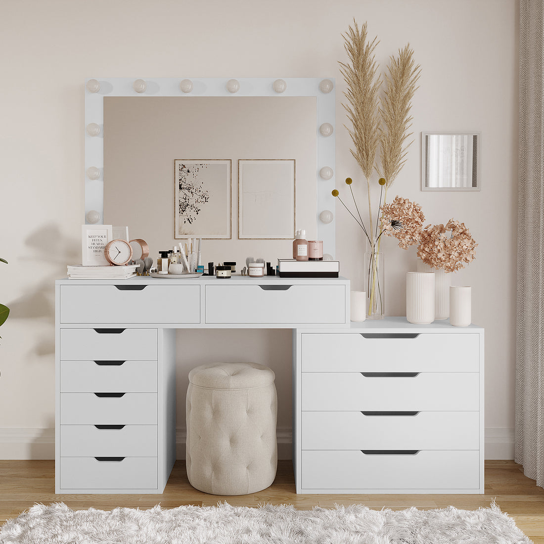 Lassie Hollywood Vanity Dressing Table with Drawers in White features a modular design, illuminated mirror with bulb-style lights, organized storage with multiple drawers, and is complemented by decorative items and a plush ottoman.