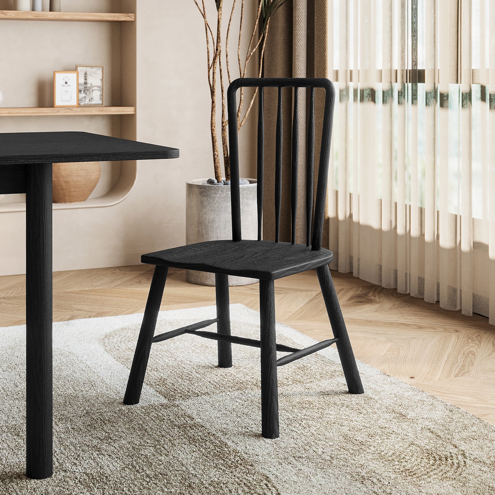 Leigh Solid Oak High-back Dining Chair Black Set of 2, featuring a slatted back and straight legs, positioned by a textured rug and large windows with sheer curtains.