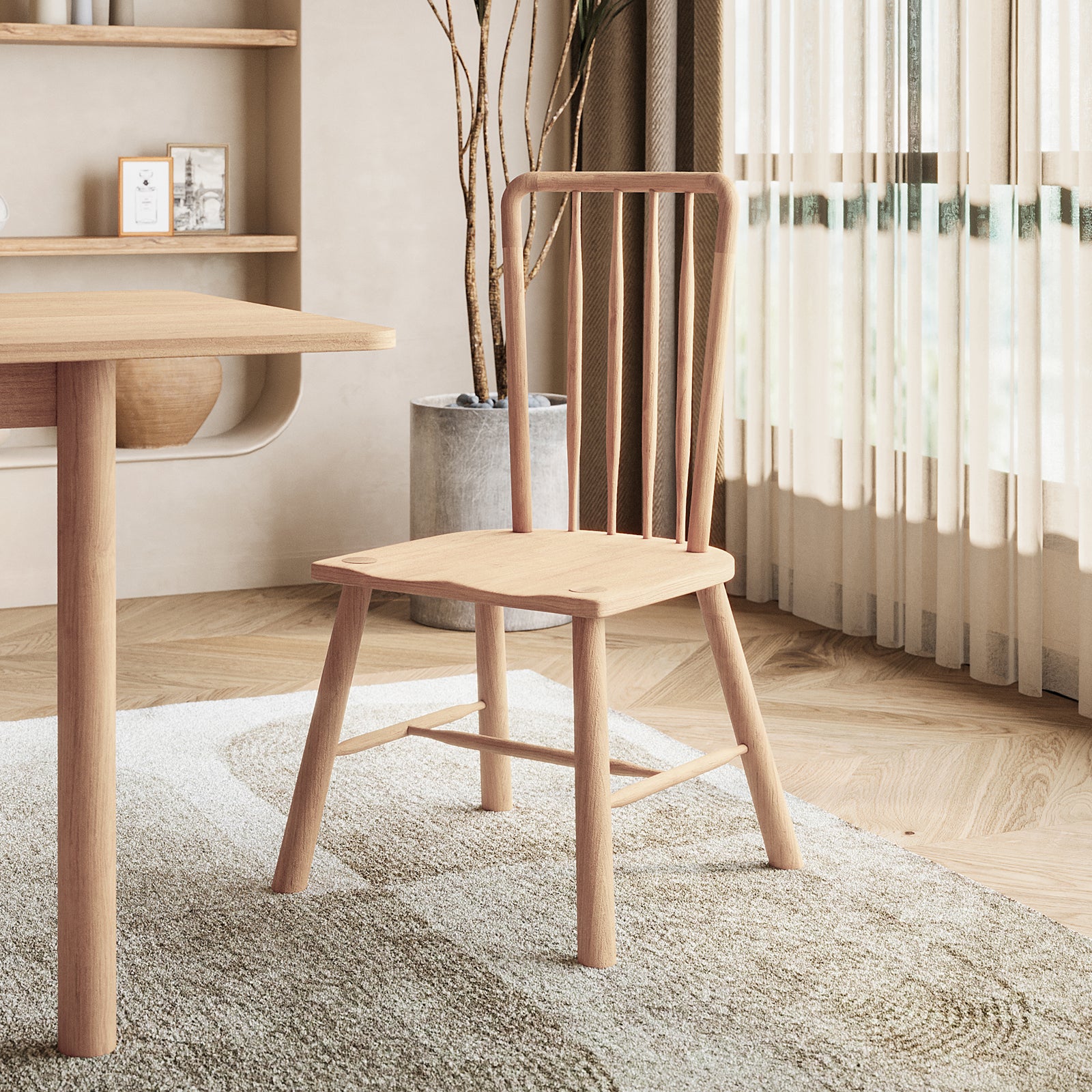 Leigh Solid Oak High-back Dining Chair Natural Set of 2, features a spindle-back design, positioned beside a matching table on a textured rug, with sheer curtains and a potted plant enhancing the room's ambiance.