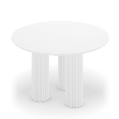 Lucina 4 Seater Fluted Round Dining Table features a sleek, white round surface with distinctive fluted pillar legs, offering a sophisticated design suited for both intimate meals and lively gatherings.