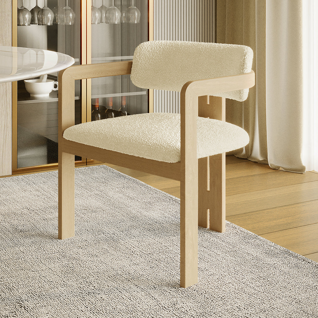 Maddi Boucle Hardwood Dining Chair featuring a curved backrest, thick cushions, and solid wood frame, showcasing its elegant, minimalist design, upholstered in soft boucle fabric, ideal for stylish, comfortable dining.