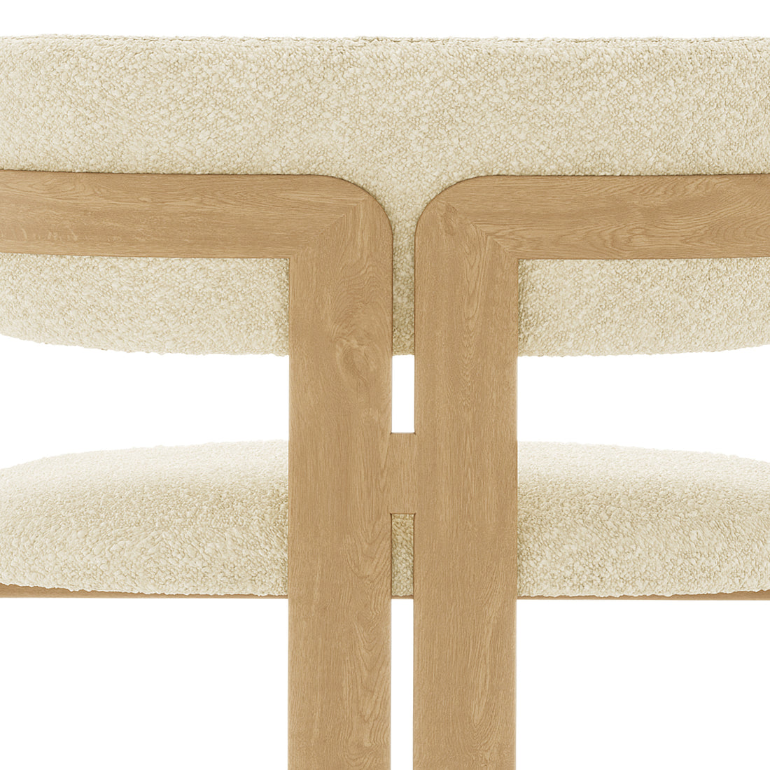 Close-up of the Maddi Boucle Hardwood Dining Chair Beige, showcasing its curved backrest, upholstered boucle fabric, thick cushions, and solid American wood frame, emphasizing its stylish and comfortable design.