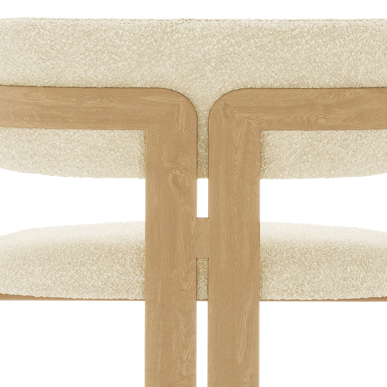 Close-up of the Maddi Boucle Hardwood Dining Chair Beige, showcasing its curved backrest, upholstered boucle fabric, thick cushions, and solid American wood frame, emphasizing its stylish and comfortable design.