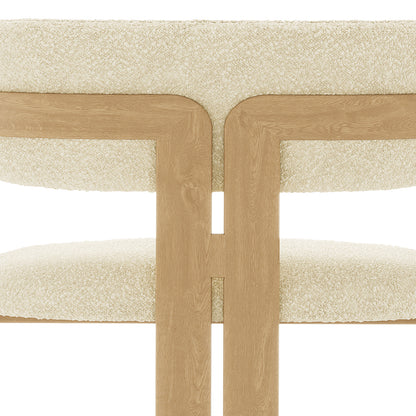 Close-up of the Maddi Boucle Hardwood Dining Chair Beige, showcasing its curved backrest, upholstered boucle fabric, thick cushions, and solid American wood frame, emphasizing its stylish and comfortable design.
