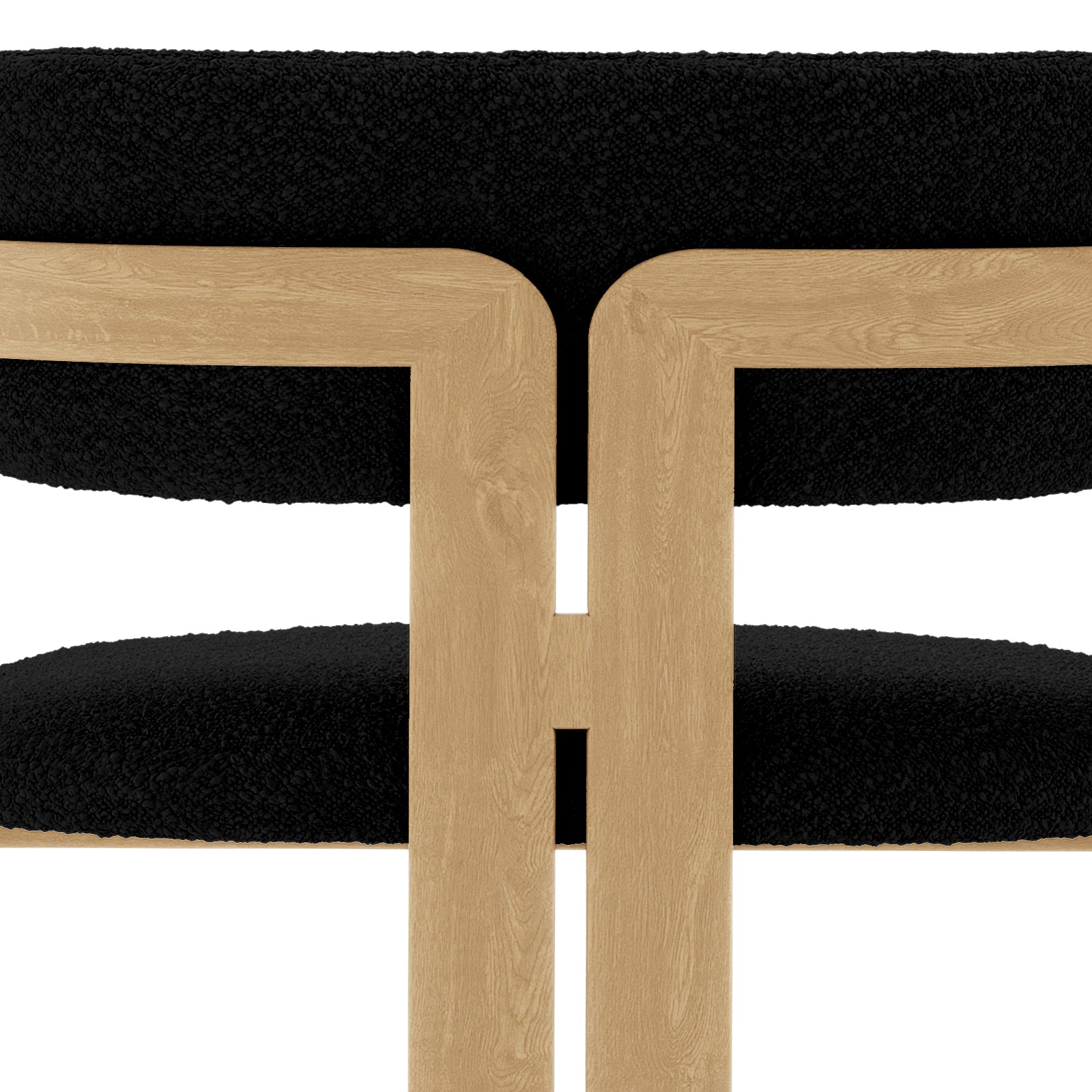 Maddi Boucle Hardwood Dining Chair Black with boucle upholstery, curved backrest, and cushioned seat, showcasing its elegant design and sturdy American wood frame for a stylish, comfortable dining experience.