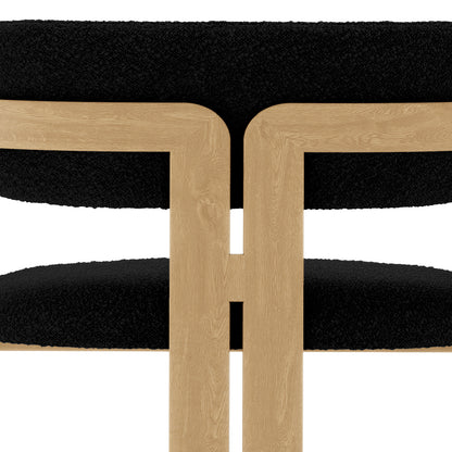Maddi Boucle Hardwood Dining Chair Black with boucle upholstery, curved backrest, and cushioned seat, showcasing its elegant design and sturdy American wood frame for a stylish, comfortable dining experience.