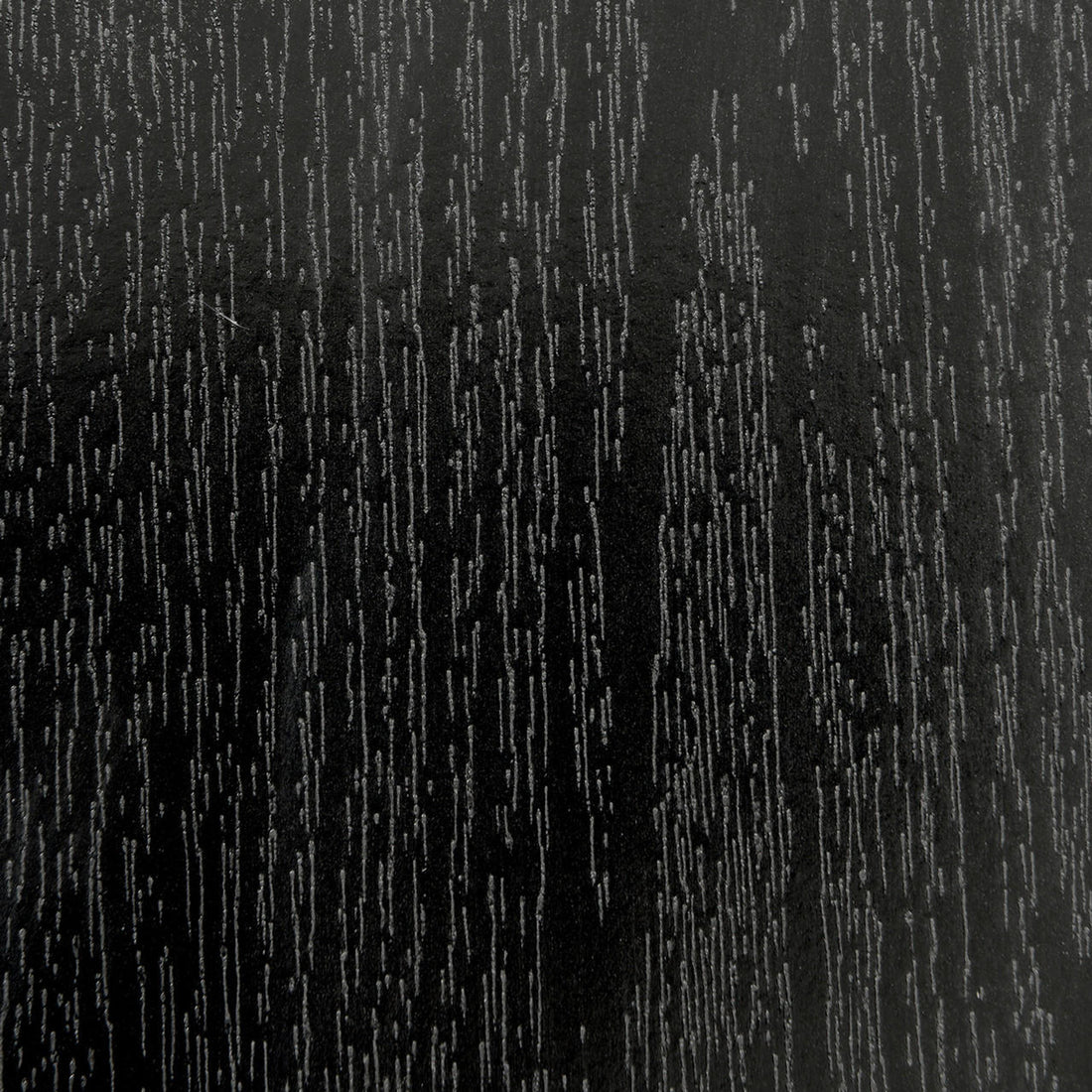 Close-up of Mae 220cm 8 Seater Rectangular Dining Table in Black, showcasing its wood-grain textured surface with lighter lines, resembling a sleek, refined, and modern tabletop design.