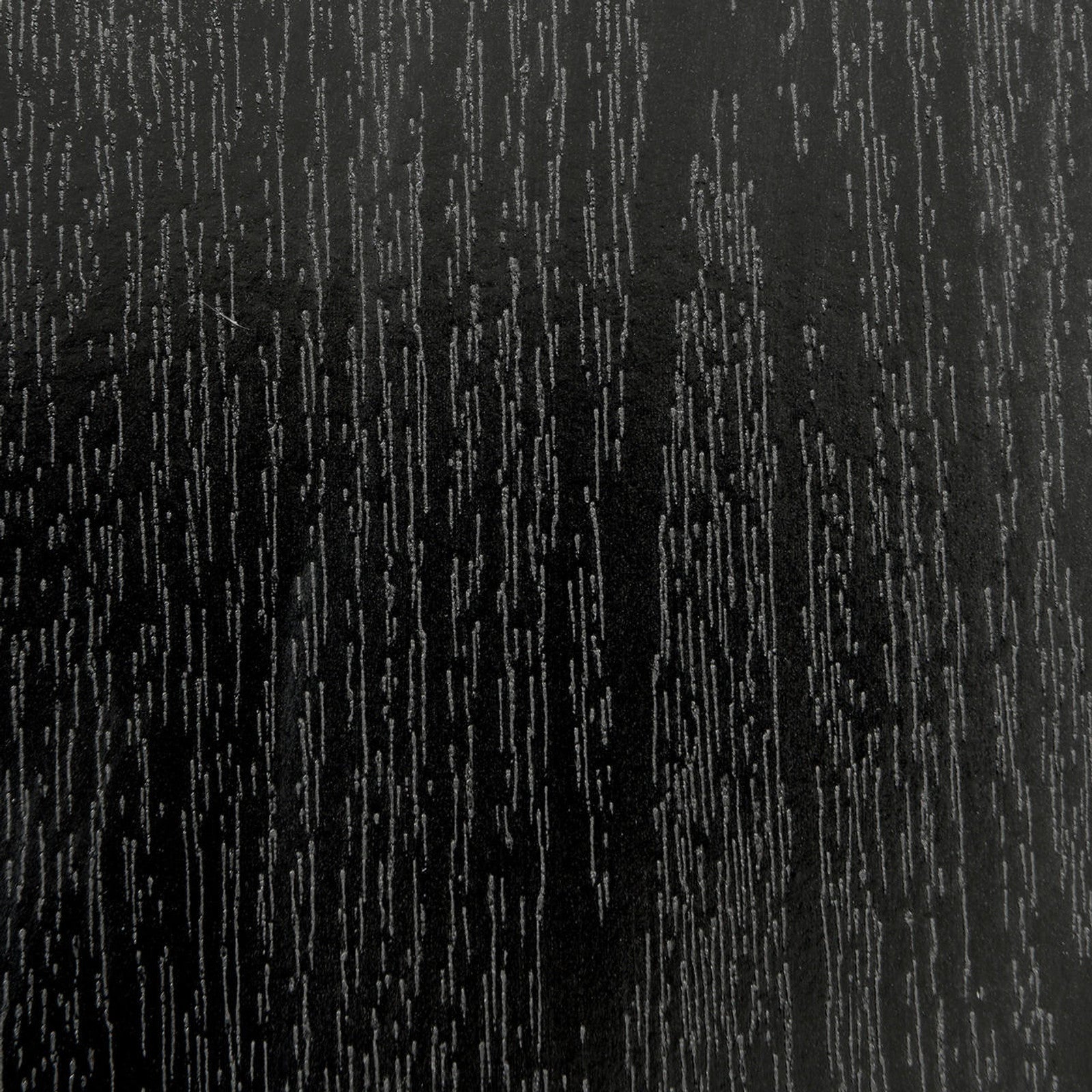 Close-up of Mae 220cm 8 Seater Rectangular Dining Table in Black, showcasing its wood-grain textured surface with lighter lines, resembling a sleek, refined, and modern tabletop design.