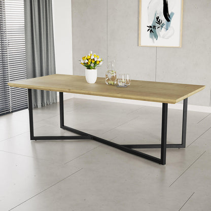 Mae 220cm 8 Seater Rectangular Dining Table in Natural with light-wood tabletop and black metal “X”-style base, adorned with a vase of tulips, a glass carafe, and drinking glasses.