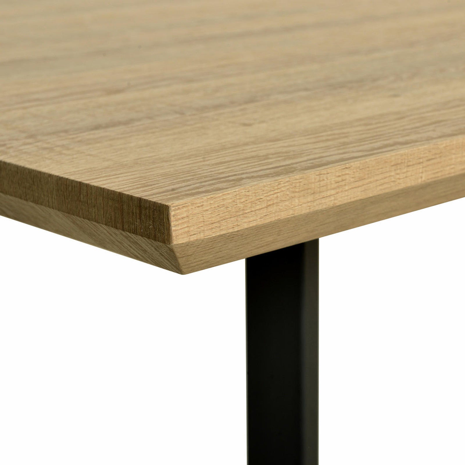 Close-up of Mae 220cm 8 Seater Rectangular Dining Table in Natural, showcasing a light wooden tabletop with a beveled edge, supported by a simple black metal leg, highlighting its elegant design.