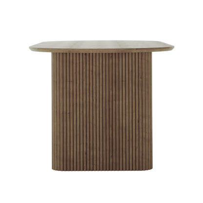 Marciana 8 Seater Fluted Oval Dining Table features a sleek, square-top design with rounded corners, supported by a central pedestal of vertical fluted slats, showcasing modern minimalist elegance in warm oak finish.
