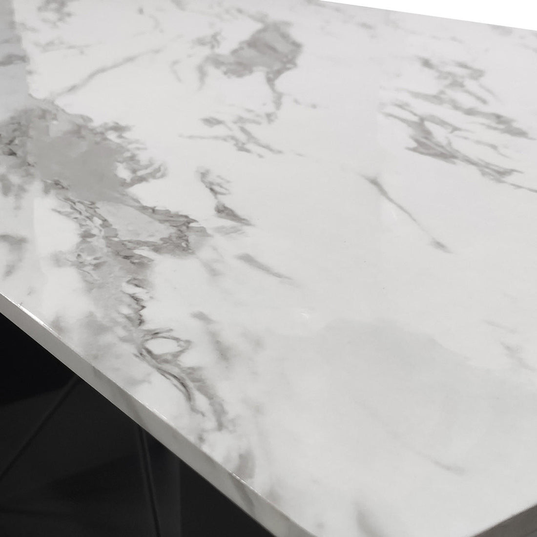 Close-up of the Mavis 180cm Dining Table with Metal Base in White, showcasing its marble-patterned surface with grey veining and squared-off edges, supported by darker metal legs underneath.