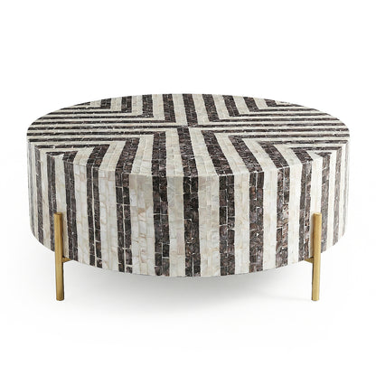 Round black and white striped coffee table with gold legs on white background