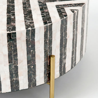 Close-up of edge and side of a mosaic patterned round table with gold leg on white background