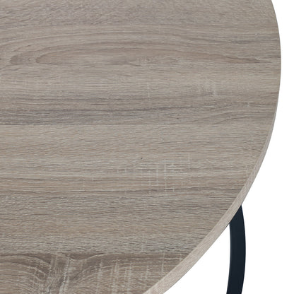 Close-up of the Nevada Round Nesting Coffee Table Set in Natural, showcasing a light, weathered-oak wood-grain tabletop with a visible black metal leg, emphasizing its modern design and space-saving functionality.