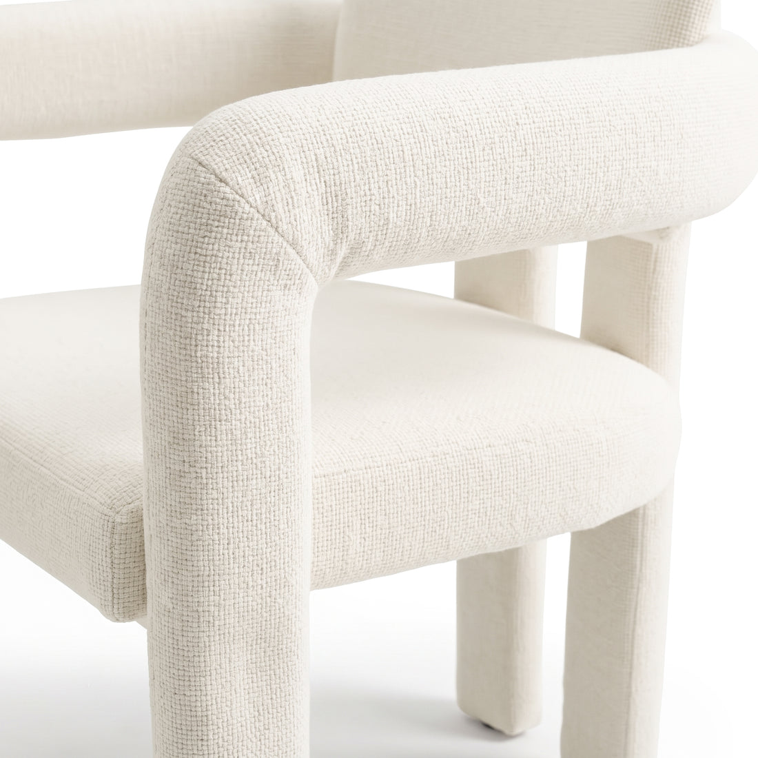Close-up partial view of a textured upholstered chair on a white background