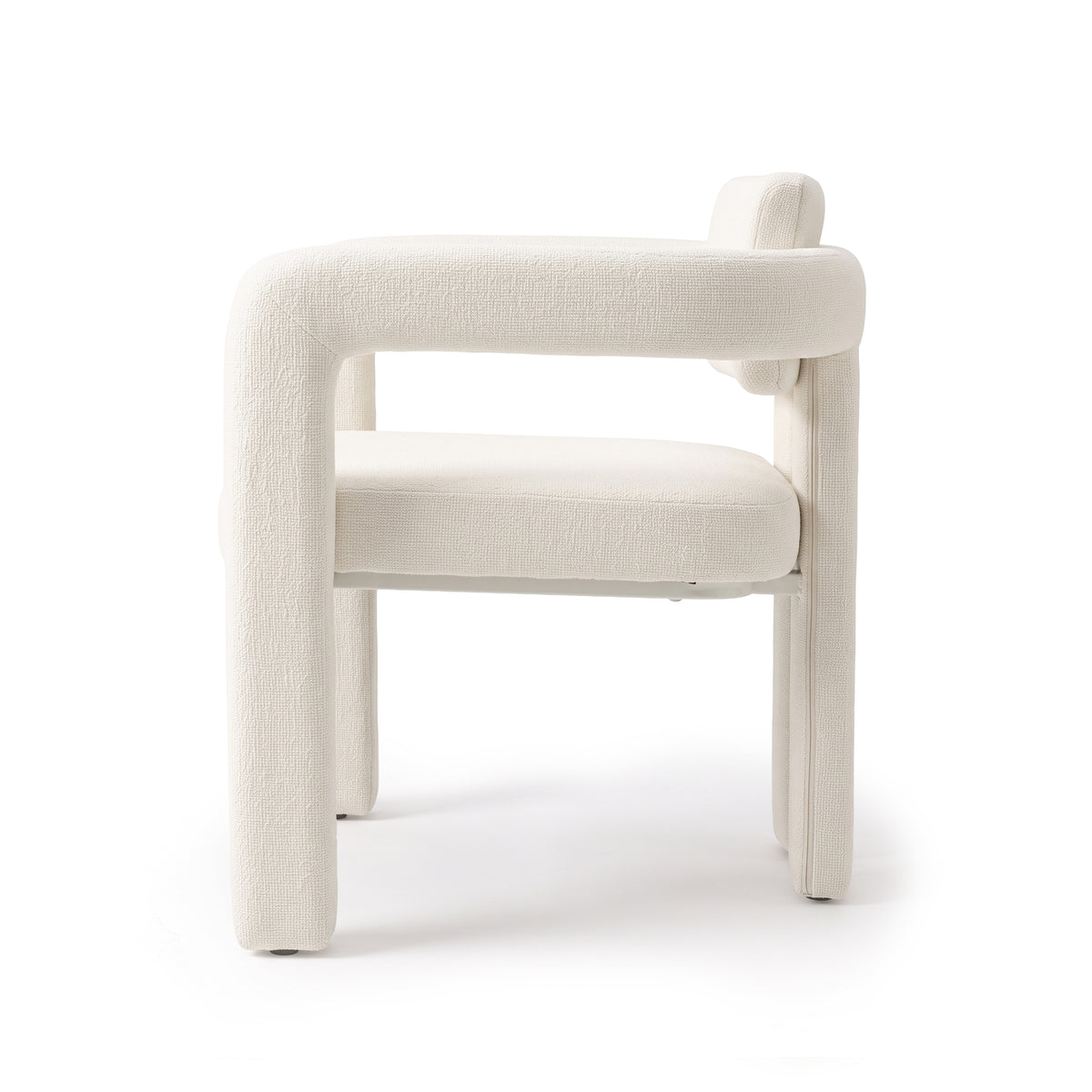 Side view of a modern upholstered chair on a white background