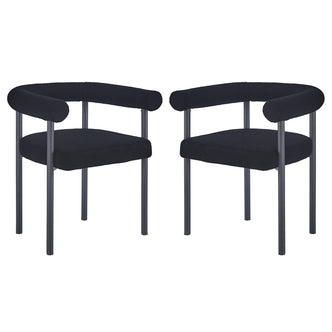 Ohio Curved Boucle Dining Chair Set of 2 in Black features low, rounded backrests and tubular armrests upholstered in black bouclé fabric, supported by sleek black metal legs for a modern look.