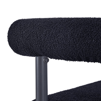 Ohio Curved Boucle Dining Chair Set of 2 in Black, featuring plush black bouclé upholstery with a tubular backrest and dark-finished metal support, exemplifying modern design and stylish comfort.