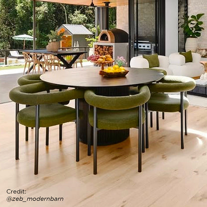 Ohio Curved Bouclé Dining Chair Set of 2 in Green, featuring a sleek black frame, tubular backrest, and slim legs, complements the indoor-outdoor dining space's modern, seamless blend of style and comfort.