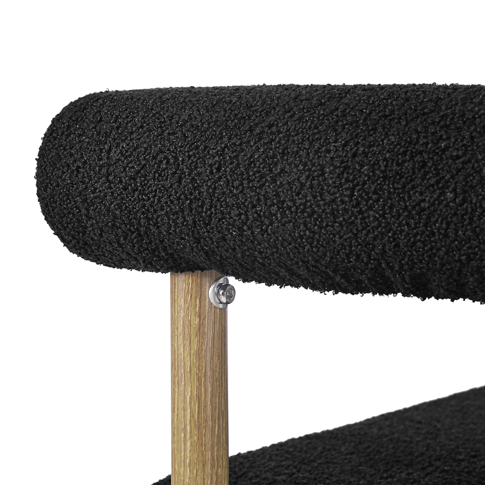 Close-up of the Ohio Curved Boucle Dining Chair Set of 2 in Black & Oak, featuring two horizontal tubular cushions in black boucle fabric, supported by a vertical wooden post with a visible bolt.