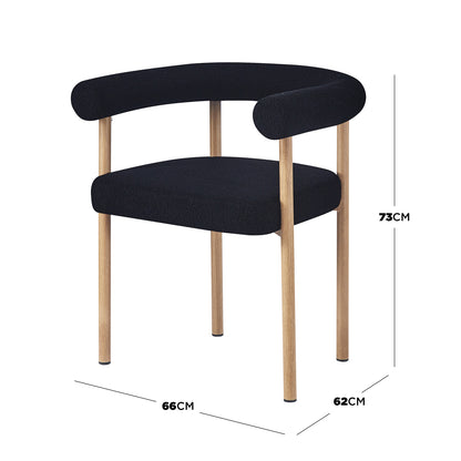 Ohio Curved Boucle Dining Chair Set of 2 in Black & Oak, featuring black boucle upholstery, light oak cylindrical legs, a curved tubular backrest with low arms, and a thick square-edged seat cushion.