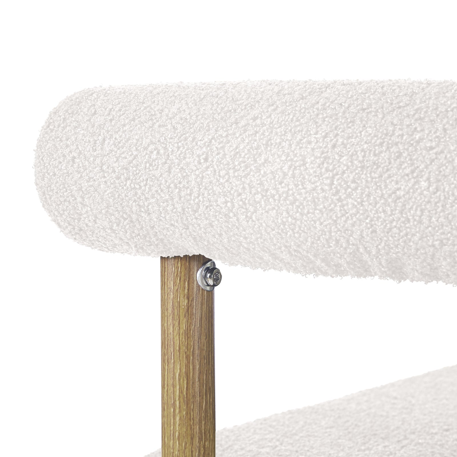 Close-up of Ohio Curved Boucle Dining Chair Set of 2 in Cream & Oak, showing rounded cream boucle cushion, oak support post, and metal bolt securing the cushion rail to the wooden frame.