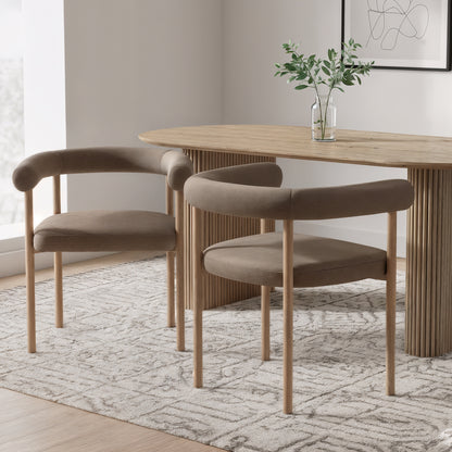 Ohio Velvet Dining Chair Set of 2 in Espresso Brown & Oak features warm taupe upholstery and slender wooden legs. Positioned around a light-wood table, these chairs enhance the minimalist dining nook with elegance.